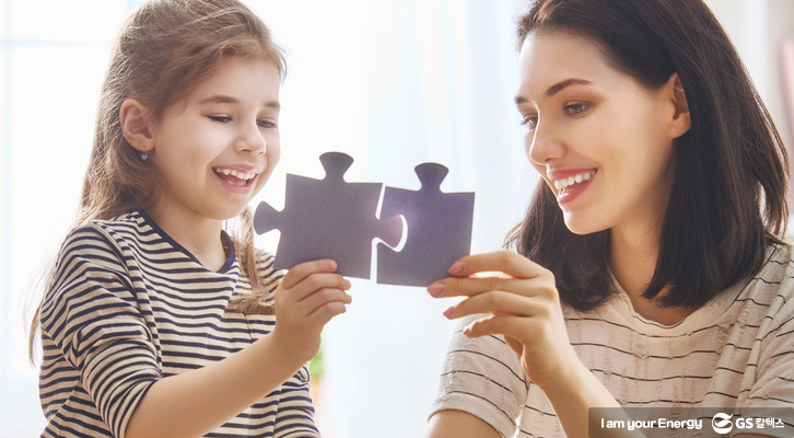 선생님과 아이가 퍼즐을 맞추고 있다